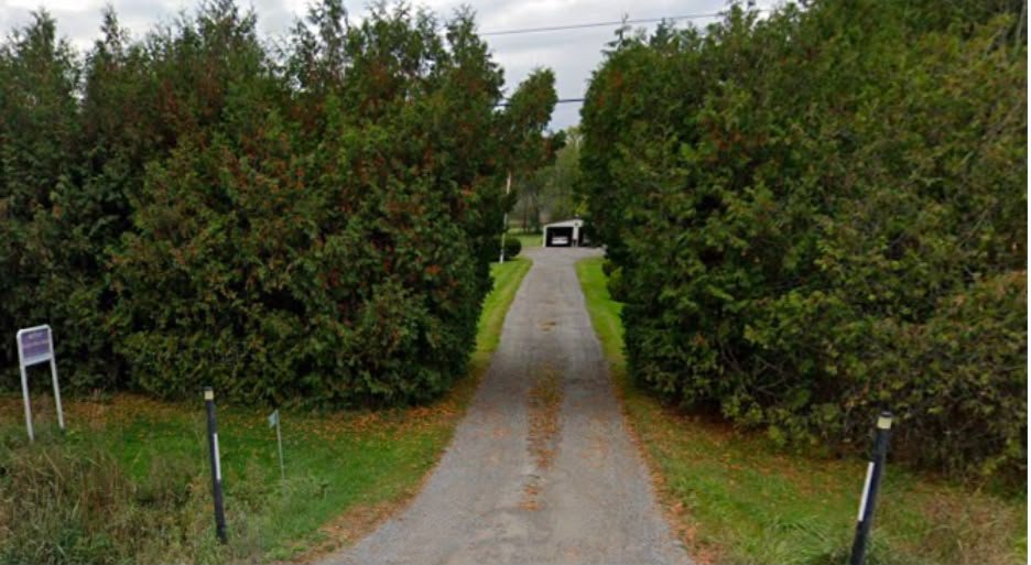 Tree-lined property entrance in Bowmanville