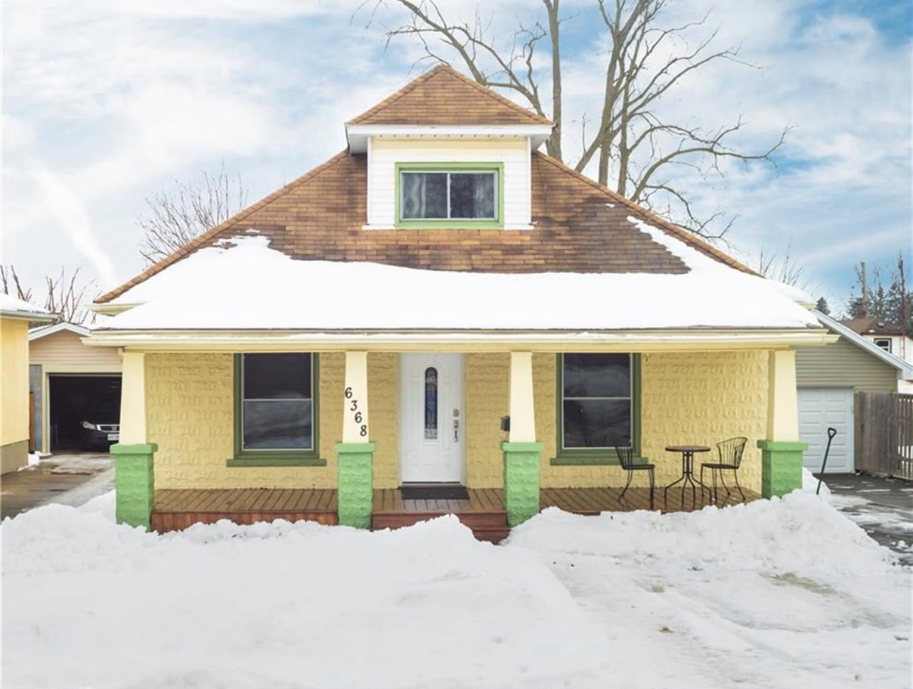 Yellow house with a covered front porch in Cambridge